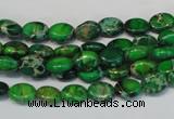 CDE178 15.5 inches 6*8mm oval dyed sea sediment jasper beads